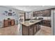 Modern kitchen with granite counters, dark cabinets, and stainless-steel appliances, perfect for home chefs at 6379 Dundock Ave, Las Vegas, NV 89122