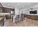 Open kitchen and living room area with dark wood cabinetry and stainless steel appliances at 6379 Dundock Ave, Las Vegas, NV 89122