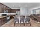Spacious kitchen with dark cabinets, granite countertops, and island with seating, great for entertaining guests at 6379 Dundock Ave, Las Vegas, NV 89122