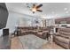Spacious living room with tile flooring, large sectional, and a view into the modern kitchen, great for gatherings at 6379 Dundock Ave, Las Vegas, NV 89122