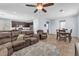 Open-concept living room with tile flooring, plush furniture, and view into the kitchen, ideal for entertaining at 6379 Dundock Ave, Las Vegas, NV 89122