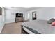 Contemporary main bedroom featuring a large TV, neutral carpeting, and an open layout at 6379 Dundock Ave, Las Vegas, NV 89122
