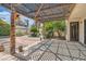 Inviting back patio with wooden pergola, landscaped yard and convenient access to the home's interior at 6417 Plumcrest Rd, Las Vegas, NV 89108