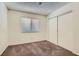 Clean bedroom featuring a standard closet, neutral carpet, and a window for natural light at 6417 Plumcrest Rd, Las Vegas, NV 89108