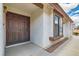 Inviting entryway with a double-door entrance and a textured facade with a neatly kept walkway at 6417 Plumcrest Rd, Las Vegas, NV 89108