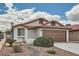 Charming home exterior featuring a low-maintenance desert landscape and an attached two-car garage at 6417 Plumcrest Rd, Las Vegas, NV 89108
