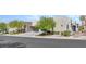 Modern home with minimalist design, xeriscaping, and spacious driveway leading to a black glass-paneled garage door at 668 Falcon Summit Ct, Henderson, NV 89012