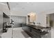 Modern kitchen with a waterfall island, dark cabinetry, and sleek appliances creates a stylish and functional space at 668 Falcon Summit Ct, Henderson, NV 89012