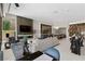 Open-concept living room and kitchen area with modern decor, fireplace, and seamless flow for entertaining at 668 Falcon Summit Ct, Henderson, NV 89012
