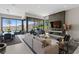 Bright living area with mountain views, tile flooring, a comfortable sofa, and built in fireplace and TV at 668 Falcon Summit Ct, Henderson, NV 89012