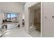 Bright main bathroom offers a soaking tub, a glass-enclosed shower, and neutral finishes at 668 Falcon Summit Ct, Henderson, NV 89012