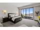 Spacious main bedroom features a large bed, stylish decor, and sliding glass doors to private outdoor space at 668 Falcon Summit Ct, Henderson, NV 89012