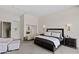 A well-lit main bedroom features a king bed, nightstands, and access to an en-suite bathroom at 668 Falcon Summit Ct, Henderson, NV 89012