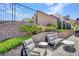 Cozy outdoor patio area with modern seating, privacy wall, and landscaping at 668 Falcon Summit Ct, Henderson, NV 89012