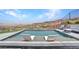 Inviting swimming pool with two chairs for relaxation, offering stunning scenic views of mountains and the city at 668 Falcon Summit Ct, Henderson, NV 89012