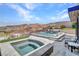 An inviting pool and hot tub offer a tranquil escape with stunning mountain views, and ample seating at 668 Falcon Summit Ct, Henderson, NV 89012