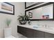 Stylish powder room with a modern vanity, elegant mirror, and decorative accents at 668 Falcon Summit Ct, Henderson, NV 89012