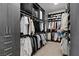 Organized walk-in closet provides plenty of space for clothing and accessories with custom storage solutions at 668 Falcon Summit Ct, Henderson, NV 89012