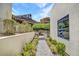 Landscaped walkway leading to a modern home on a hillside at 668 Falcon Summit Ct, Henderson, NV 89012