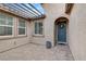 Inviting entryway with a paver patio, pergola, and a stylish blue front door at 6814 Willowcroft St, Las Vegas, NV 89149