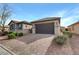 Single-story home with a paver driveway, two-car garage, and desert landscaping at 6814 Willowcroft St, Las Vegas, NV 89149