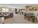 Open-concept living space with a comfortable sectional sofa, dining area, and kitchen island at 6814 Willowcroft St, Las Vegas, NV 89149