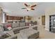 Spacious living room with a sectional sofa, and an open layout to the kitchen and dining areas at 6814 Willowcroft St, Las Vegas, NV 89149