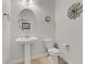 Bright powder room with pedestal sink, oval mirror, and neutral wall decor at 6814 Willowcroft St, Las Vegas, NV 89149