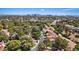 Panoramic aerial view of residential neighborhood with mature trees and city skyline on the horizon at 6925 Emerald Springs Ln, Las Vegas, NV 89113