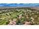 Expansive aerial view overlooking the golf course and community featuring red tile roofs and desert mountain scenery at 6925 Emerald Springs Ln, Las Vegas, NV 89113