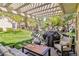 Relaxing backyard patio with comfortable seating, grill, and serene water views at 6925 Emerald Springs Ln, Las Vegas, NV 89113