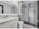 Modern bathroom with sleek white vanity, illuminated mirror, and frameless glass shower at 6925 Emerald Springs Ln, Las Vegas, NV 89113