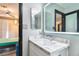 Elegant bathroom featuring a marble countertop, sleek white vanity and LED mirror at 6925 Emerald Springs Ln, Las Vegas, NV 89113