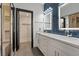 Bright bathroom featuring a double sink vanity, luxury tile backsplash, and a walk-in shower at 6925 Emerald Springs Ln, Las Vegas, NV 89113