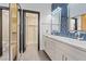 Bathroom with a double sink vanity, luxury tile backsplash, and a walk-in shower at 6925 Emerald Springs Ln, Las Vegas, NV 89113
