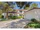 Well-maintained townhome features an attached garage, lush landscaping, and a welcoming front exterior at 6925 Emerald Springs Ln, Las Vegas, NV 89113