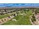 Golf course aerial view, showcasing manicured greens, mature trees and a picturesque mountain backdrop at 6925 Emerald Springs Ln, Las Vegas, NV 89113