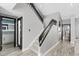 Bright hallway with a staircase featuring wood-style floors and black accents at 6925 Emerald Springs Ln, Las Vegas, NV 89113