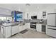Bright kitchen with white cabinetry, stainless appliances, marble counters, and an open layout at 6925 Emerald Springs Ln, Las Vegas, NV 89113