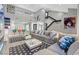 Bright and spacious living room featuring a vaulted ceiling, stairs, and a large sectional sofa at 6925 Emerald Springs Ln, Las Vegas, NV 89113