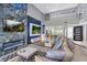 Open-concept living room featuring high ceilings, modern fireplace, TV, and stylish decor at 6925 Emerald Springs Ln, Las Vegas, NV 89113