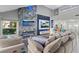 Bright living room with a vaulted ceiling, fireplace, media center, and an open layout into the kitchen at 6925 Emerald Springs Ln, Las Vegas, NV 89113