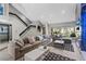 Bright living room featuring stairs, recessed lighting, and a large sectional sofa for comfortable seating at 6925 Emerald Springs Ln, Las Vegas, NV 89113