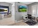 Bright office with a modern desk, accent wall and open view to the living room at 6925 Emerald Springs Ln, Las Vegas, NV 89113