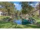 Scenic view of a tranquil pond reflecting the surrounding trees and townhomes, creating a peaceful atmosphere at 6925 Emerald Springs Ln, Las Vegas, NV 89113