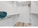 Walk-in closet with custom shelving and racks, perfect for storage and organization at 6925 Emerald Springs Ln, Las Vegas, NV 89113