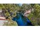 Scenic waterfront view, showcasing lush trees surrounding a serene and reflective lake with patio seating area at 6925 Emerald Springs Ln, Las Vegas, NV 89113