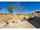 Backyard with a patio featuring gravel landscaping, a manicured lawn, and beautiful views of the golf course at 7649 Broadwing Dr, North Las Vegas, NV 89084