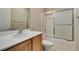Bathroom featuring a large vanity with a sink, toilet, and a shower with a glass door at 7649 Broadwing Dr, North Las Vegas, NV 89084