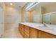 Bright bathroom with double sinks, spacious vanity, and a large mirror and shower at 7649 Broadwing Dr, North Las Vegas, NV 89084